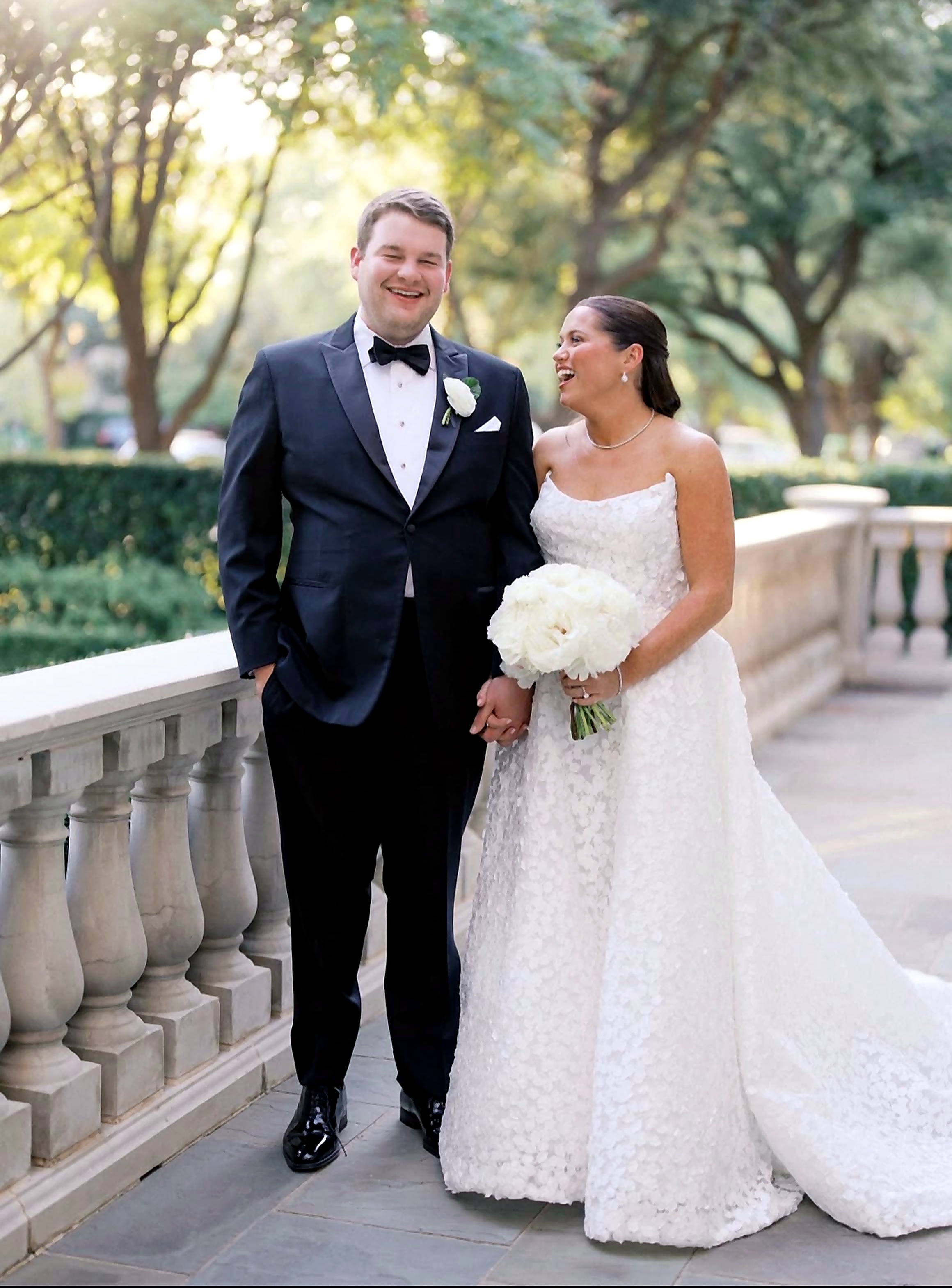 Bride and groom on a garden terrace, full-length.